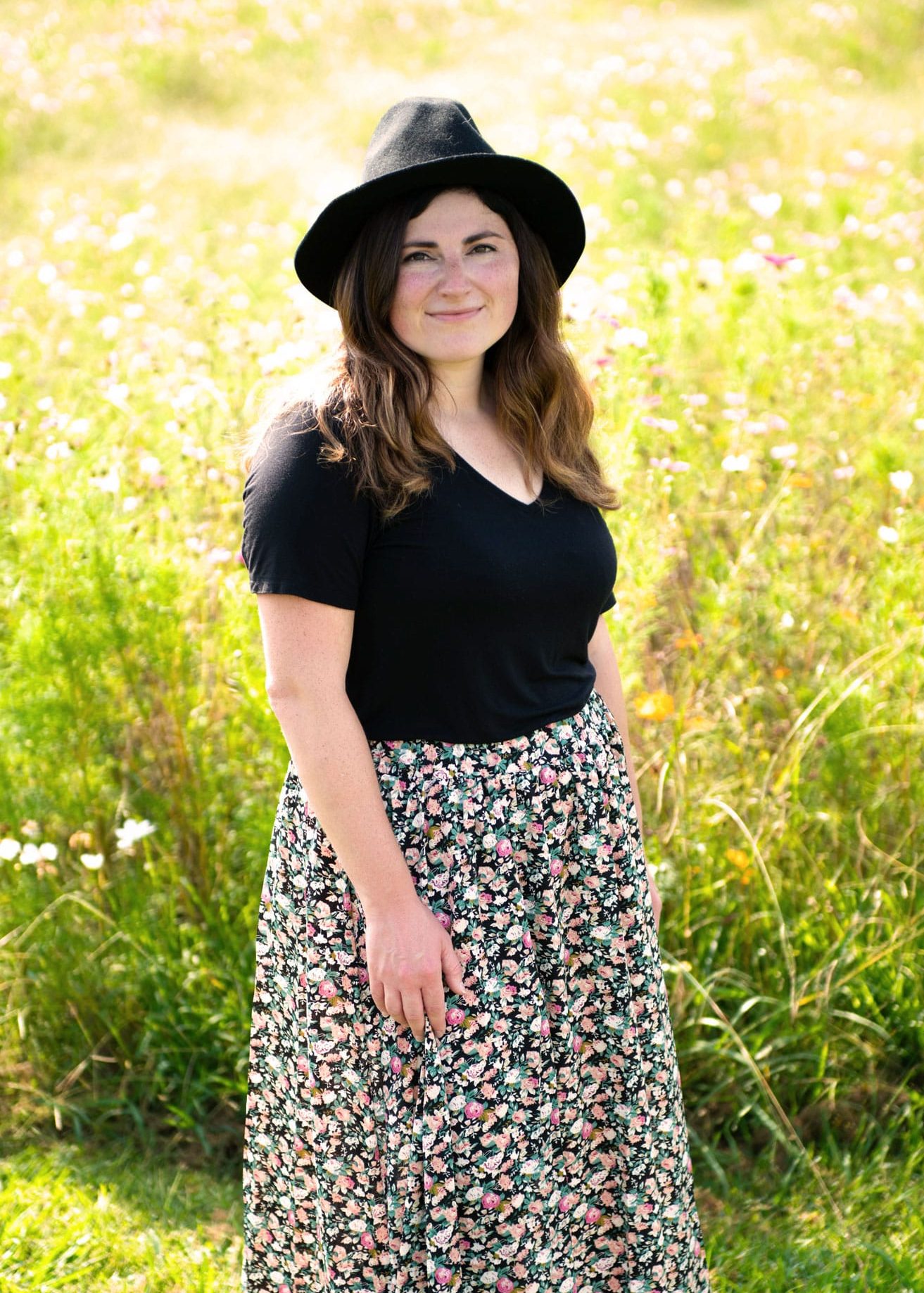 Kalie Sands, web designer and founder of Wild Heart Design, photographed in a field of flowers