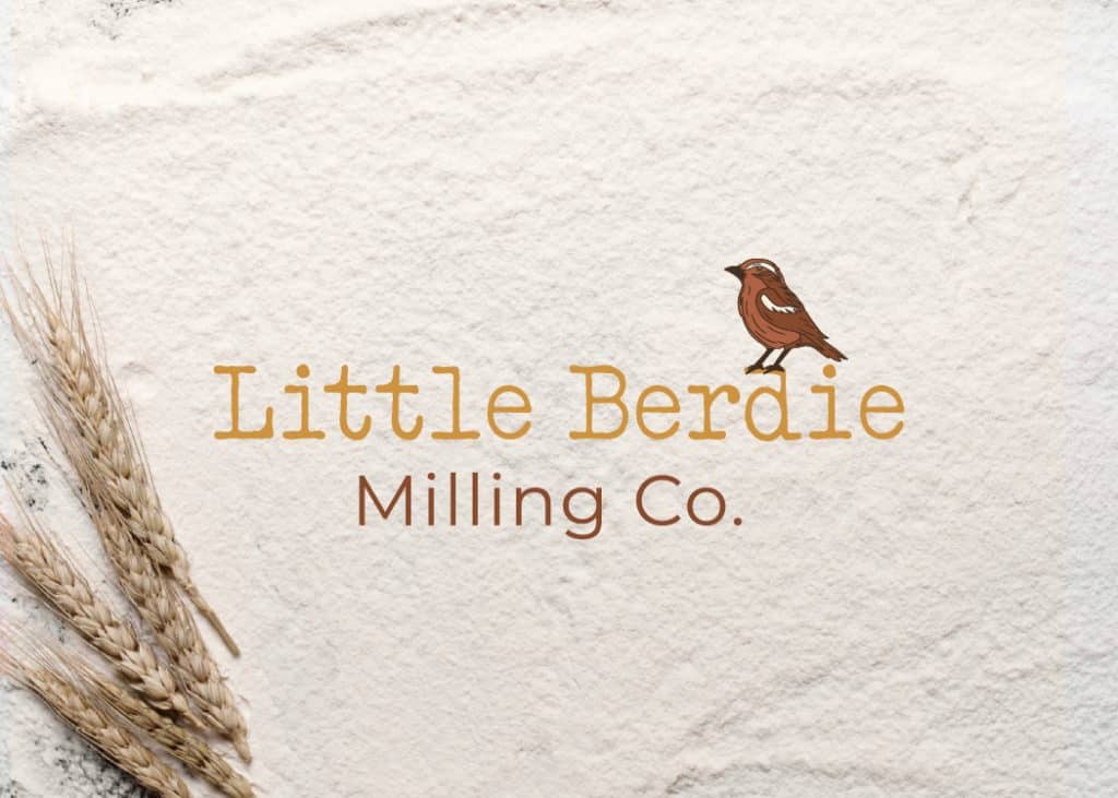 Little Berdie Milling Co. logo with mockingbird icon displayed on a flour and wheat background