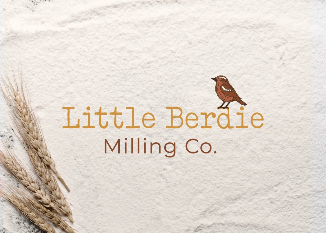 Little Berdie Milling Co. logo with mockingbird icon displayed on a flour and wheat background