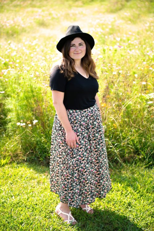 Kalie Sands, web designer and founder of Wild Heart Design, photographed in a field of flowers